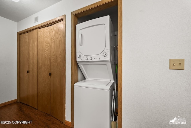 8641 Blackberry St # 6B, Anchorage, AK 99502 - laundry area featuring estacked washer and dryer and wood finished floors