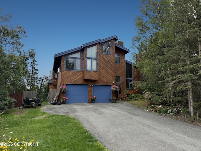 6770 Round Tree Dr, Anchorage, AK 99507 - view of front of home with a chimney, driveway, and an attached garage