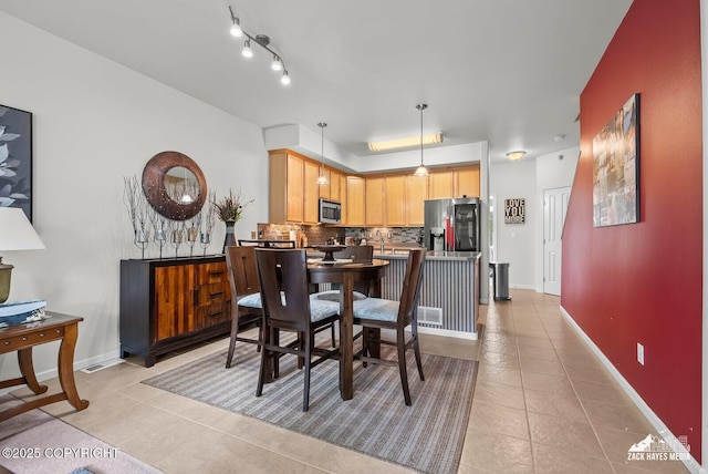 7655 Stepping Stone Ln Unit Q2, Anchorage, AK 99504 - dining area featuring light tile patterned flooring and baseboards