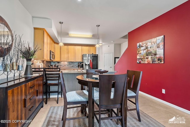7655 Stepping Stone Ln Unit Q2, Anchorage, AK 99504 - dining area featuring light tile patterned flooring and baseboards