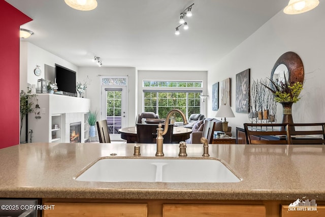 7655 Stepping Stone Ln Unit Q2, Anchorage, AK 99504 - kitchen with open floor plan, a fireplace, and track lighting