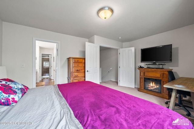 7655 Stepping Stone Ln Unit Q2, Anchorage, AK 99504 - carpeted bedroom with a glass covered fireplace and baseboards