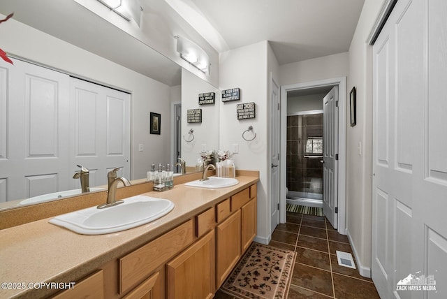 7655 Stepping Stone Ln Unit Q2, Anchorage, AK 99504 - full bathroom featuring double vanity, tile patterned floors, and a shower