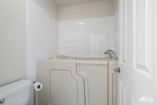 7655 Stepping Stone Ln Unit Q2, Anchorage, AK 99504 - bathroom with a garden tub and tile walls