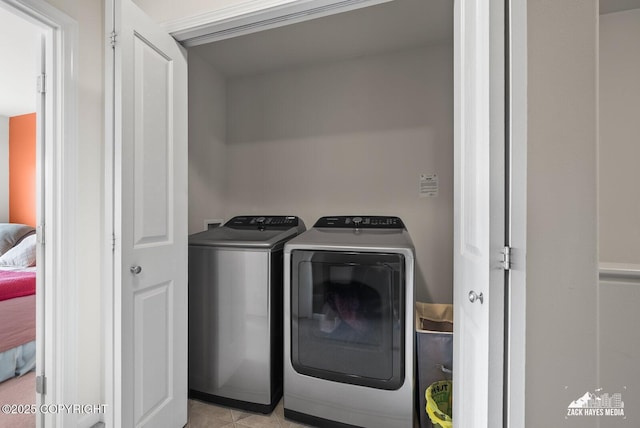 7655 Stepping Stone Ln Unit Q2, Anchorage, AK 99504 - laundry room with washer and clothes dryer and light tile patterned floors