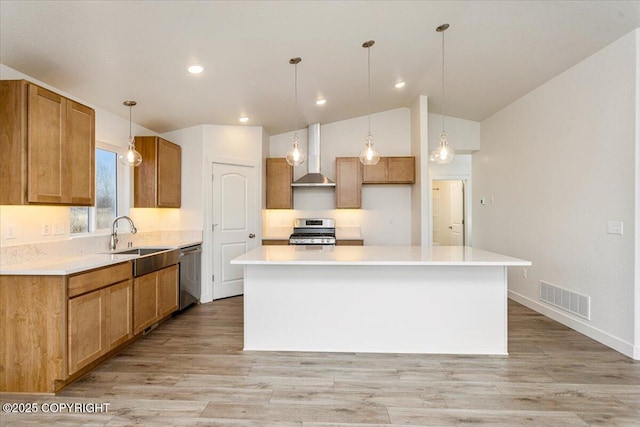 4125 E Zircon Cir, Wasilla, AK 99654 - kitchen with stainless steel appliances, wall chimney range hood, lofted ceiling, light wood-style flooring, and light countertops