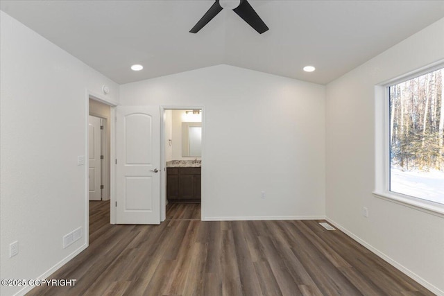 4125 E Zircon Cir, Wasilla, AK 99654 - unfurnished bedroom featuring dark wood-type flooring, multiple windows, lofted ceiling, recessed lighting, and ensuite bathroom