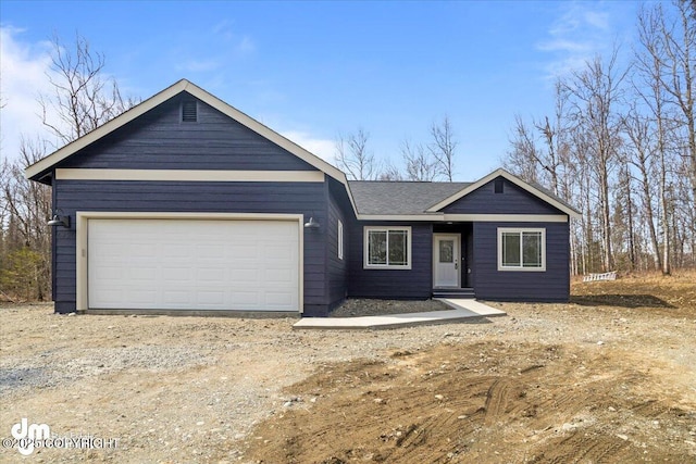 4125 E Zircon Cir, Wasilla, AK 99654 - ranch-style house with dirt driveway and an attached garage
