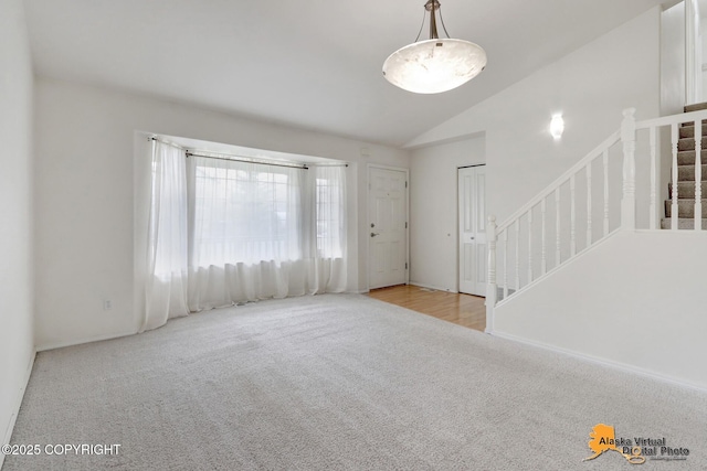 2321 Lusardi Point Cir, Anchorage, AK 99515 - unfurnished living room with carpet, stairs, and lofted ceiling