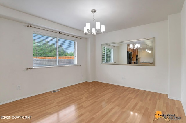 2321 Lusardi Point Cir, Anchorage, AK 99515 - spare room with a chandelier and light wood-style floors