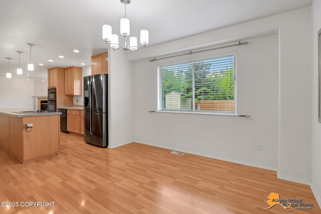 2321 Lusardi Point Cir, Anchorage, AK 99515 - kitchen featuring black appliances, light wood-style floors, a chandelier, recessed lighting, and decorative light fixtures