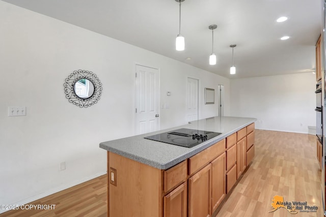 2321 Lusardi Point Cir, Anchorage, AK 99515 - kitchen with black electric stovetop, light wood-style floors, a kitchen island, decorative light fixtures, and brown cabinets