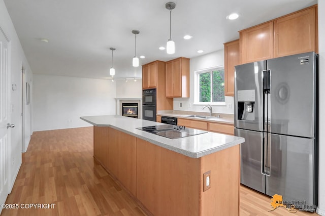 2321 Lusardi Point Cir, Anchorage, AK 99515 - kitchen featuring black appliances, light countertops, light wood-style flooring, a center island, and hanging light fixtures