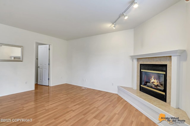 2321 Lusardi Point Cir, Anchorage, AK 99515 - unfurnished living room with light wood-type flooring and a tile fireplace