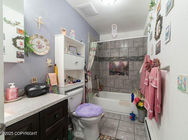282 Marydale Ct, Soldotna, AK 99669 - full bath featuring baseboard heating, tile patterned flooring, vanity, and shower / bath combination with curtain