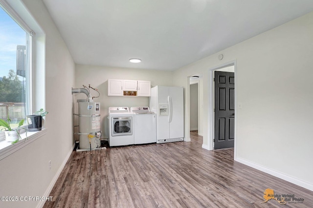 14795 E Hearthstone Dr, Palmer, AK 99645 - laundry room with cabinet space, strapped water heater, washer and dryer, and wood finished floors