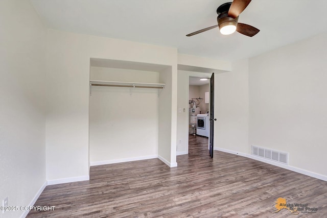 14795 E Hearthstone Dr, Palmer, AK 99645 - unfurnished bedroom with washer / dryer, wood finished floors, a closet, and a ceiling fan
