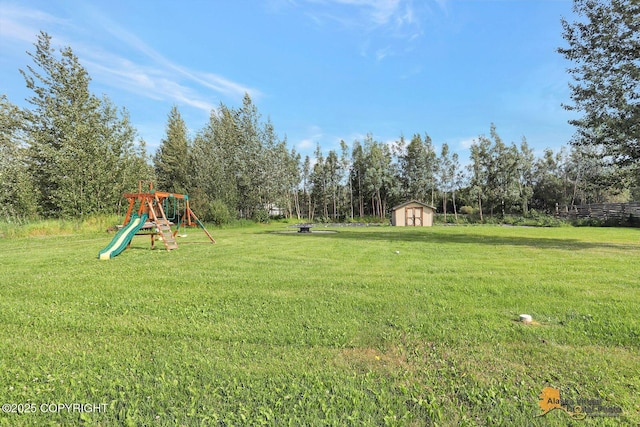 14795 E Hearthstone Dr, Palmer, AK 99645 - view of green lawn with a playground and a storage unit