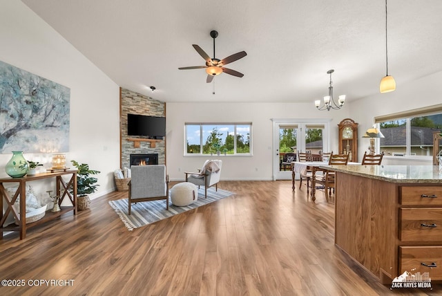 23011 Sherman St # 24, Chugiak, AK 99567 - living area with a fireplace, a ceiling fan, light wood-type flooring, a chandelier, and vaulted ceiling