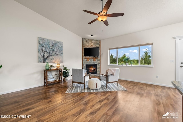 23011 Sherman St # 24, Chugiak, AK 99567 - sitting room with vaulted ceiling, a ceiling fan, a fireplace, and wood finished floors