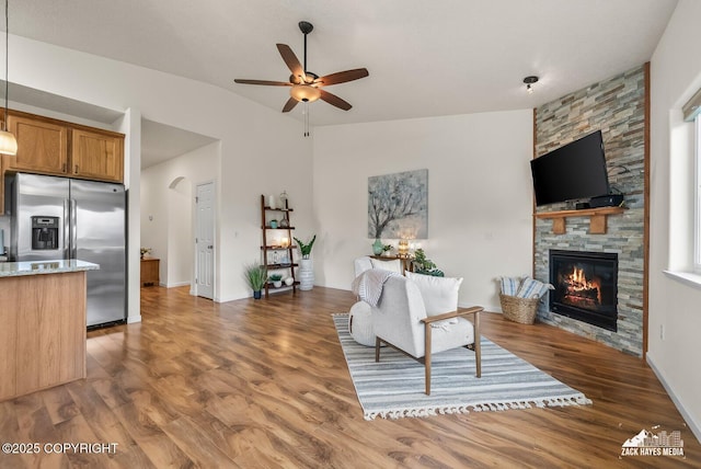 23011 Sherman St # 24, Chugiak, AK 99567 - living room with ceiling fan, a fireplace, vaulted ceiling, and wood finished floors