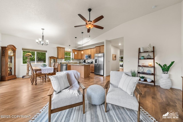 23011 Sherman St # 24, Chugiak, AK 99567 - living area with a chandelier, ceiling fan, light wood-style flooring, and high vaulted ceiling