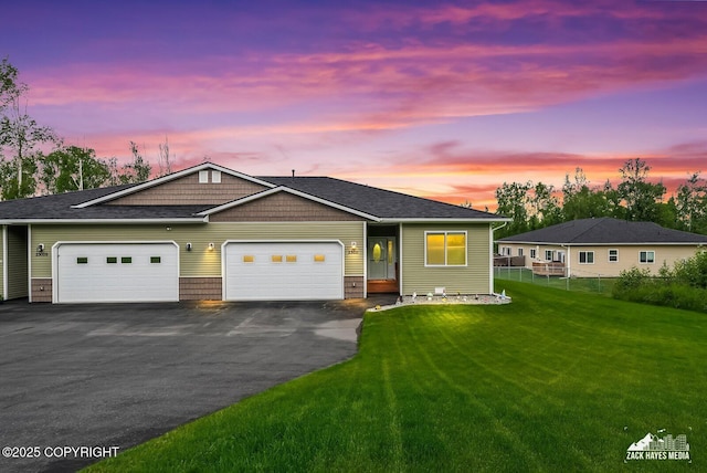 23011 Sherman St # 24, Chugiak, AK 99567 - view of front facade featuring asphalt driveway, an attached garage, and roof with shingles