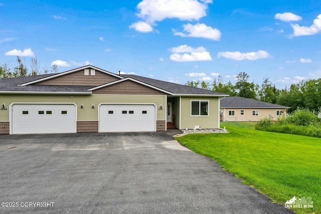 23011 Sherman St # 24, Chugiak, AK 99567 - view of front of home featuring a front lawn, a garage, and asphalt driveway