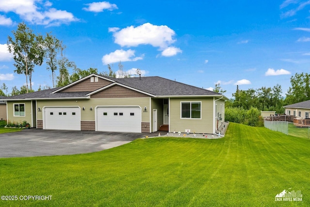 23011 Sherman St # 24, Chugiak, AK 99567 - view of front of home with driveway, a garage, a front yard, and roof with shingles