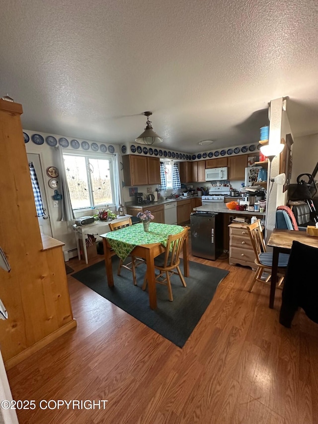 2541 Lyvona Ln, Anchorage, AK 99502 - dining area with a textured ceiling and light wood-type flooring