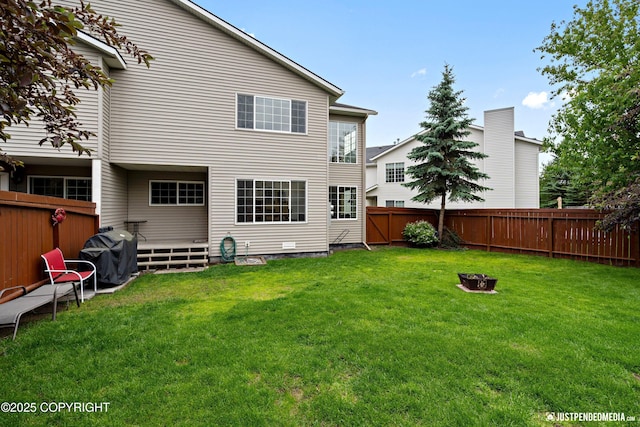 2431 Harbor Landing Cir, Anchorage, AK 99515 - back of house featuring a fenced backyard, a deck, and an outdoor fire pit