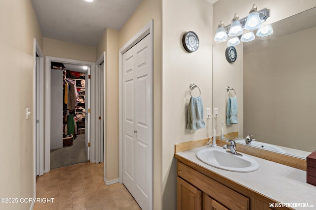 2431 Harbor Landing Cir, Anchorage, AK 99515 - bathroom featuring vanity and a spacious closet
