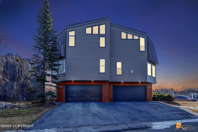 1854 Buccaneer Pl, Anchorage, AK 99501 - property exterior at dusk featuring driveway and a garage