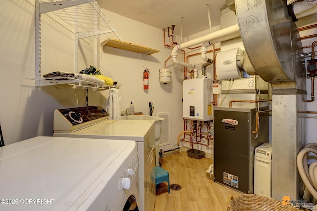 1854 Buccaneer Pl, Anchorage, AK 99501 - laundry area featuring separate washer and dryer, tankless water heater, and light wood finished floors