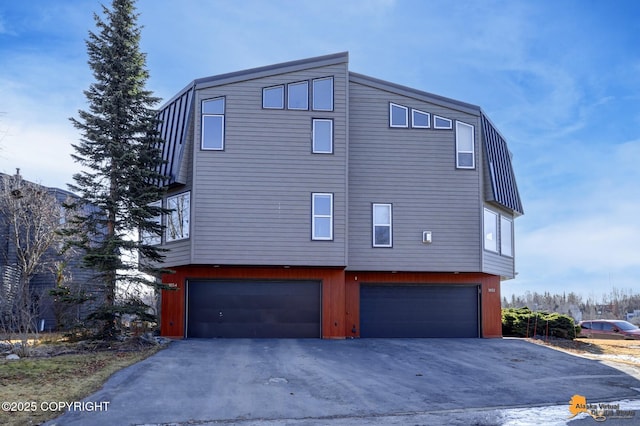 1854 Buccaneer Pl, Anchorage, AK 99501 - view of side of property with a garage and driveway