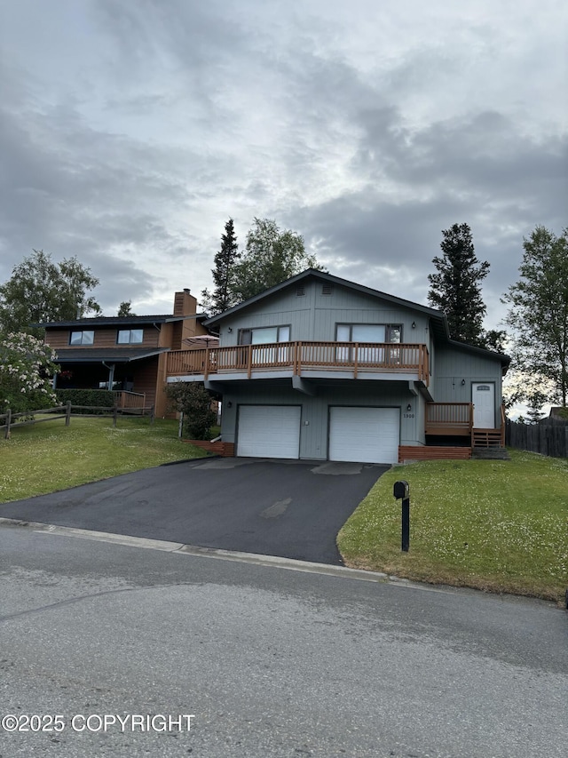 1900 Rebel Ridge Dr, Anchorage, AK 99504 - view of front facade with asphalt driveway, an attached garage, and a wooden deck
