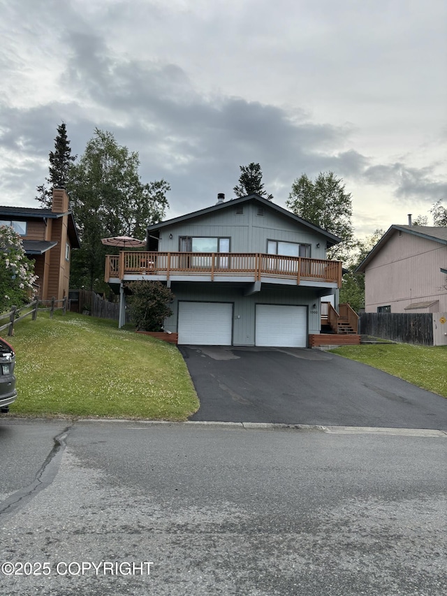 1900 Rebel Ridge Dr, Anchorage, AK 99504 - rustic home with asphalt driveway, an attached garage, and a wooden deck