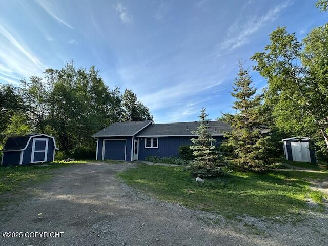 950 E Chugach View Dr, Wasilla, AK 99654 - ranch-style home featuring a storage unit, an attached garage, and dirt driveway