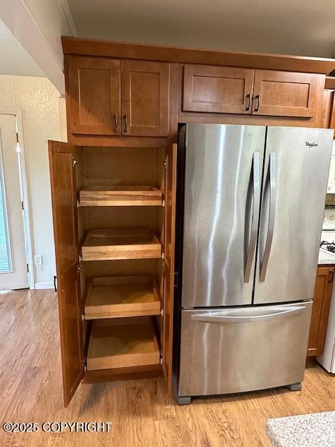 950 E Chugach View Dr, Wasilla, AK 99654 - kitchen with freestanding refrigerator, light wood finished floors, and brown cabinets