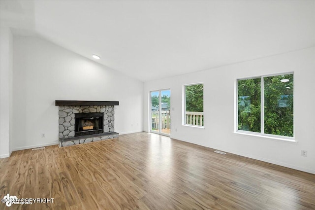 1250 W Josselin Ln, Palmer, AK 99645 - unfurnished living room featuring vaulted ceiling, wood finished floors, and a fireplace