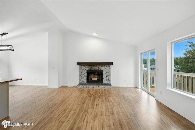 1250 W Josselin Ln, Palmer, AK 99645 - unfurnished living room with light wood-style floors, lofted ceiling, and a stone fireplace