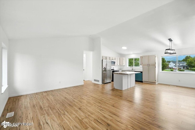 1250 W Josselin Ln, Palmer, AK 99645 - unfurnished living room featuring vaulted ceiling and light wood-style flooring