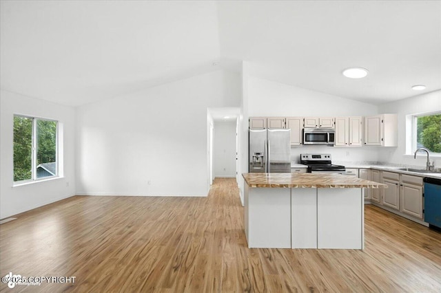 1250 W Josselin Ln, Palmer, AK 99645 - kitchen with stainless steel appliances, a kitchen island, vaulted ceiling, light wood-style flooring, and wood counters