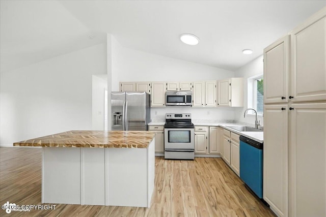 1250 W Josselin Ln, Palmer, AK 99645 - kitchen with stainless steel appliances, lofted ceiling, wooden counters, light wood-style flooring, and a kitchen island