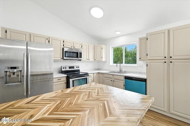 1250 W Josselin Ln, Palmer, AK 99645 - kitchen featuring appliances with stainless steel finishes, lofted ceiling, and light countertops
