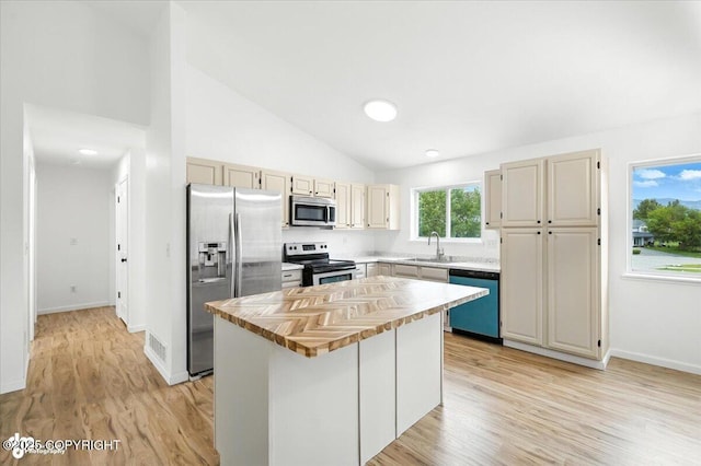 1250 W Josselin Ln, Palmer, AK 99645 - kitchen featuring stainless steel appliances, light wood finished floors, a kitchen island, wooden counters, and high vaulted ceiling