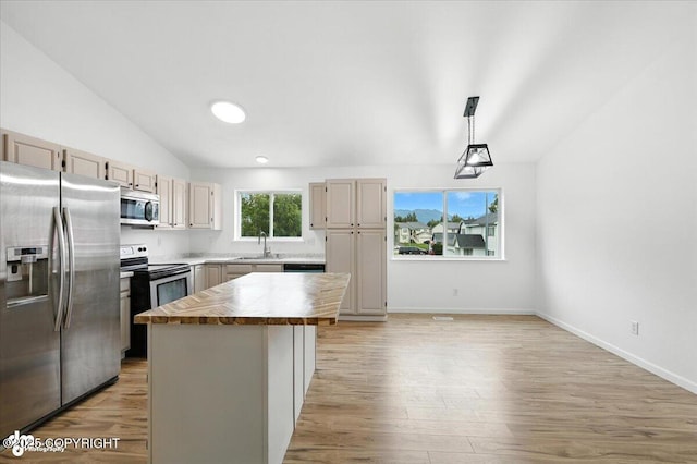 1250 W Josselin Ln, Palmer, AK 99645 - kitchen with appliances with stainless steel finishes, vaulted ceiling, wooden counters, a center island, and light wood finished floors