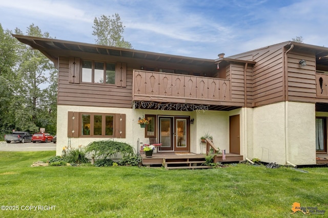 4840 Bryn Mawr Ct Unit 3, Anchorage, AK 99508 - rear view of property featuring a balcony, stucco siding, and a yard