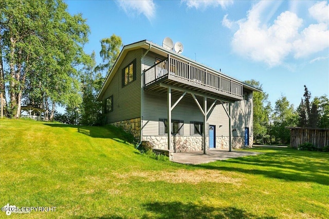 43725 Ross Dr, Soldotna, AK 99669 - rear view of property with a yard, a wooden deck, a patio, and stone siding