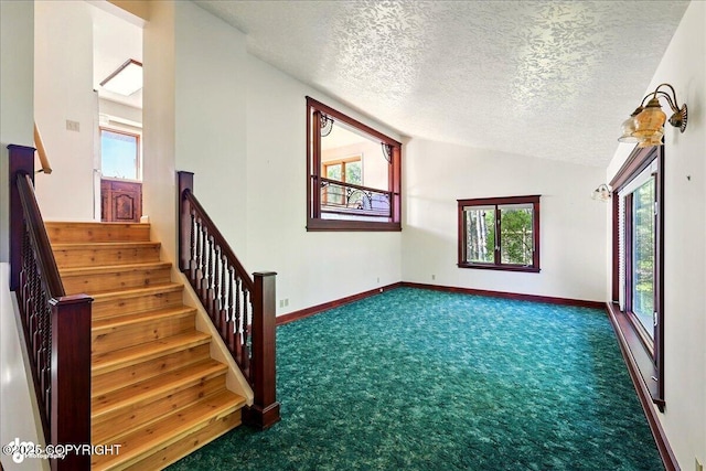 43725 Ross Dr, Soldotna, AK 99669 - stairs featuring carpet flooring, a textured ceiling, and vaulted ceiling
